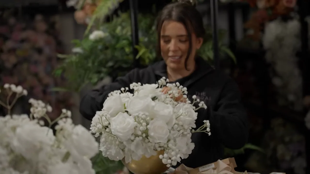 Conversation and flower selection alternate with arranging stems.